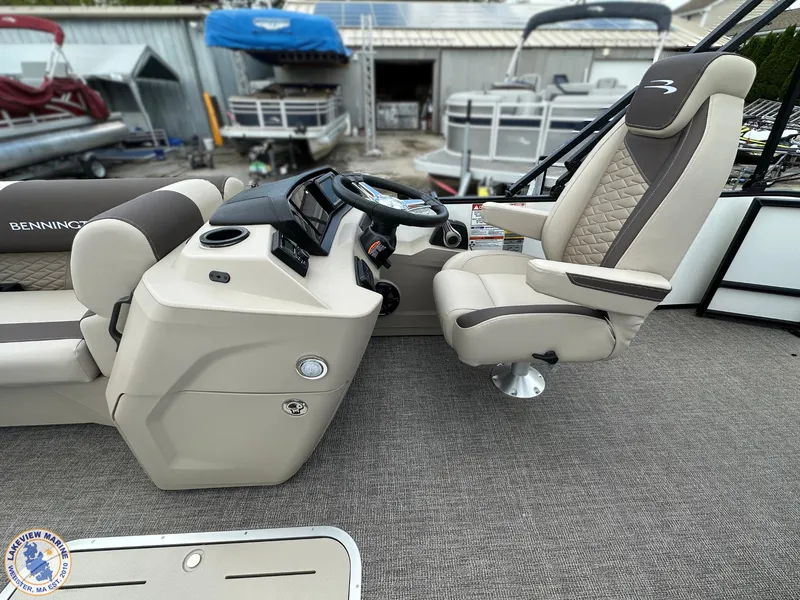 Slide: The Image of 2025 Bennington 21 SL boat interior with captain's chair and control console. - 6