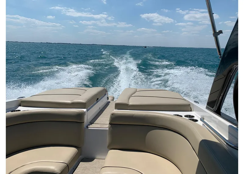 Slide: The Image of 2015 Rinker 276 Captiva Cuddy cruising on open water, leaving a wake behind. - 10