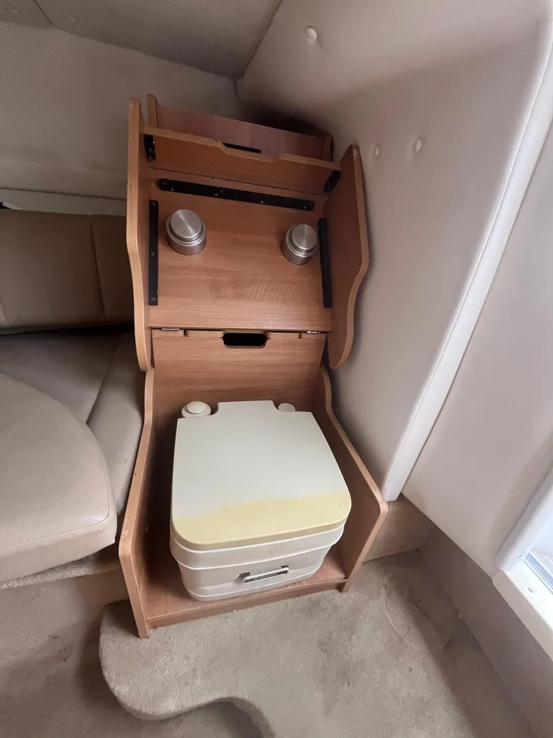 Slide: The Image of Interior of 2015 Rinker 276 Captiva Cuddy with compact portable toilet. - 14