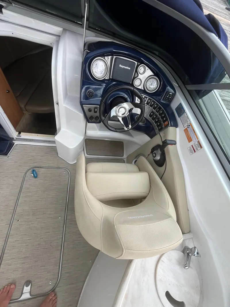 Slide: The Image of 2015 Rinker 276 Captiva Cuddy cockpit with steering wheel and control panel. - 3