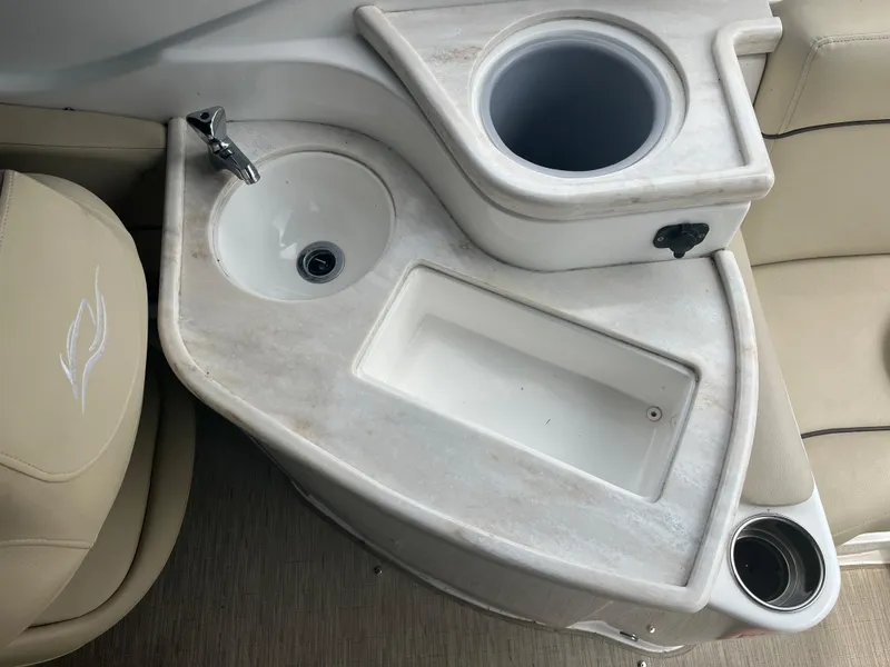 Slide: The Image of 2015 Rinker 276 Captiva Cuddy boat interior with sink and cup holders. - 4