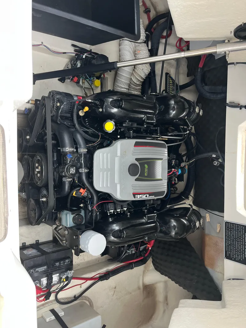 Slide: The Image of Engine compartment of a 2015 Rinker 276 Captiva Cuddy boat, featuring a 350 MAG engine. - 8