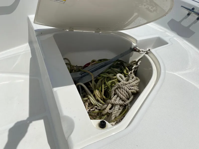 Slide: The Image of Open storage compartment on 2017 Boston Whaler 150 Super Sport with ropes and anchor. - 10