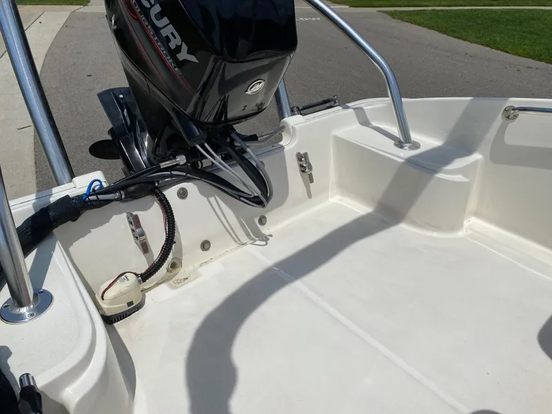 Slide: The Image of 2017 Boston Whaler 150 Super Sport boat interior with Mercury outboard motor. - 15