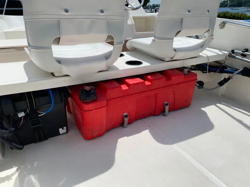 Slide: The Image of 2017 Boston Whaler 150 Super Sport interior with red fuel tank and seating. - 16