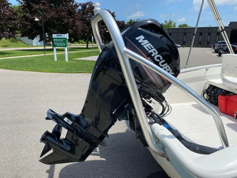 Slide: The Image of 2017 Boston Whaler 150 Super Sport with Mercury outboard engine, parked outdoors. - 18