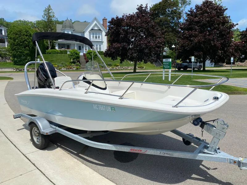 Slide: The Image of 2017 Boston Whaler 150 Super Sport boat on trailer, parked in residential area. - 5