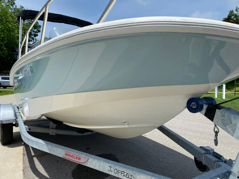 Slide: The Image of 2017 Boston Whaler 150 Super Sport boat on trailer, side view. - 6