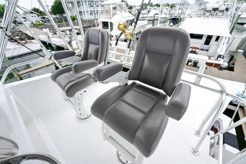 Slide: The Image of Luxury seating on a 1995 Viking 50 yacht, docked at a marina. - 10