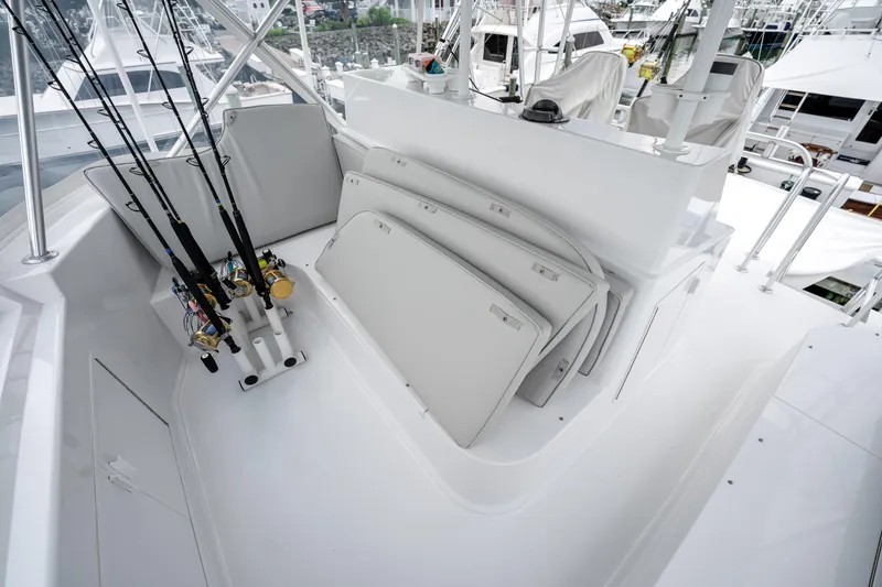 Slide: The Image of 1995 Viking 50 yacht deck with fishing rods and storage compartments. - 11