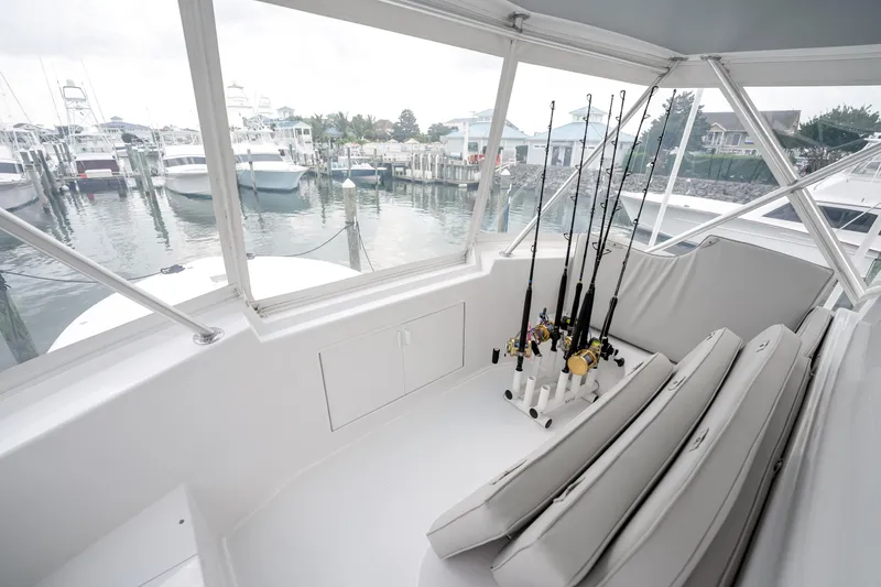 Slide: The Image of Interior view of a 1995 Viking 50 yacht with fishing rods and marina backdrop. - 12