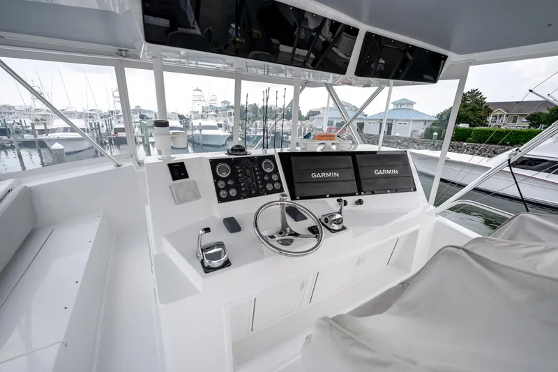 Slide: The Image of Helm of 1995 Viking 50 yacht with Garmin navigation, docked at marina. - 15