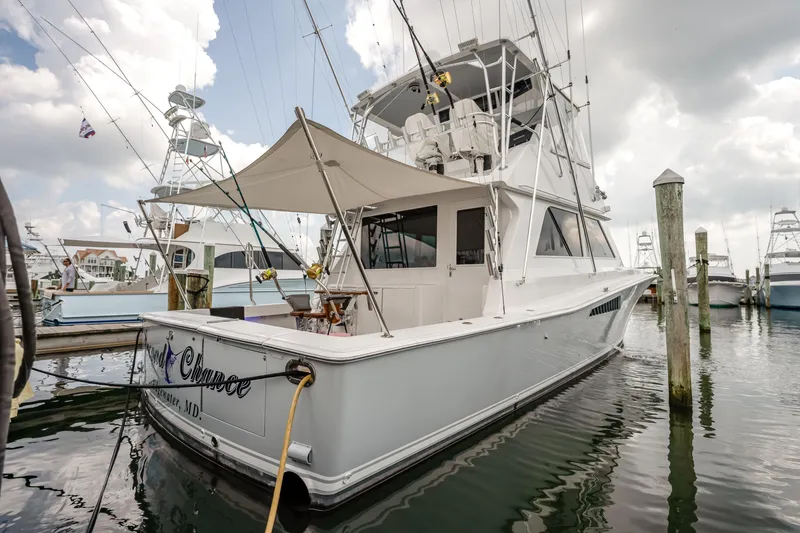 Slide: The Image of 1995 Viking 50 yacht docked at marina under cloudy sky. - 17
