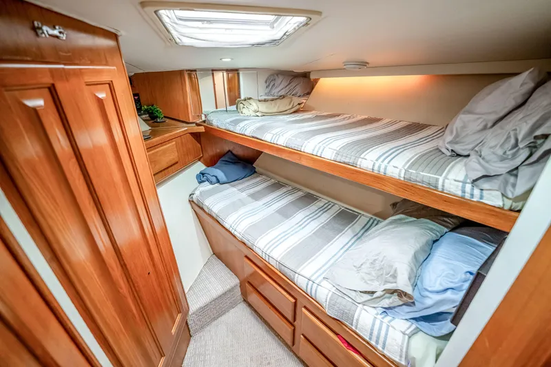 Slide: The Image of Cozy bunk beds in a 1995 Viking 50 yacht cabin with wooden interior. - 19
