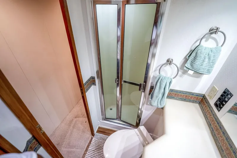 Slide: The Image of Compact bathroom in 1995 Viking 50 yacht with shower and teal towels. - 20