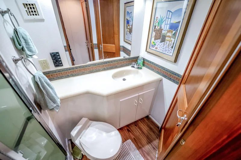 Slide: The Image of Bathroom interior of 1995 Viking 50 yacht with sink, toilet, and decorative artwork. - 21