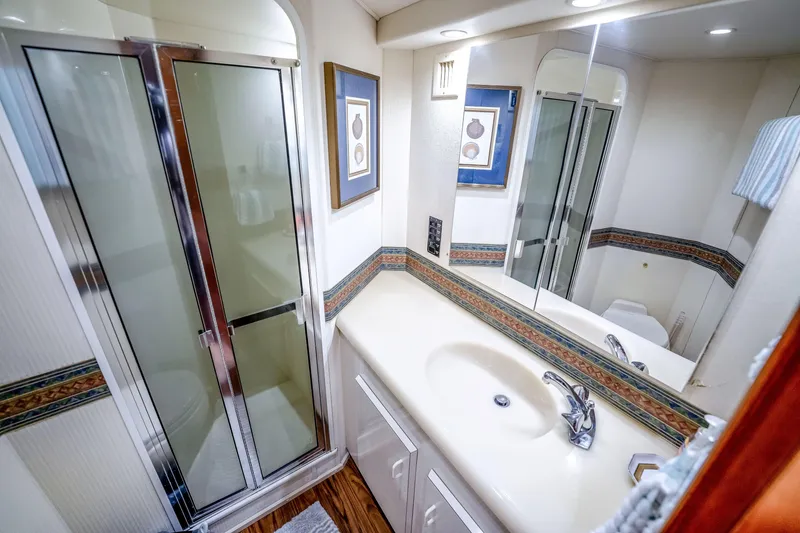 Slide: The Image of Luxurious bathroom in 1995 Viking 50 yacht with shower, sink, and elegant decor. - 25