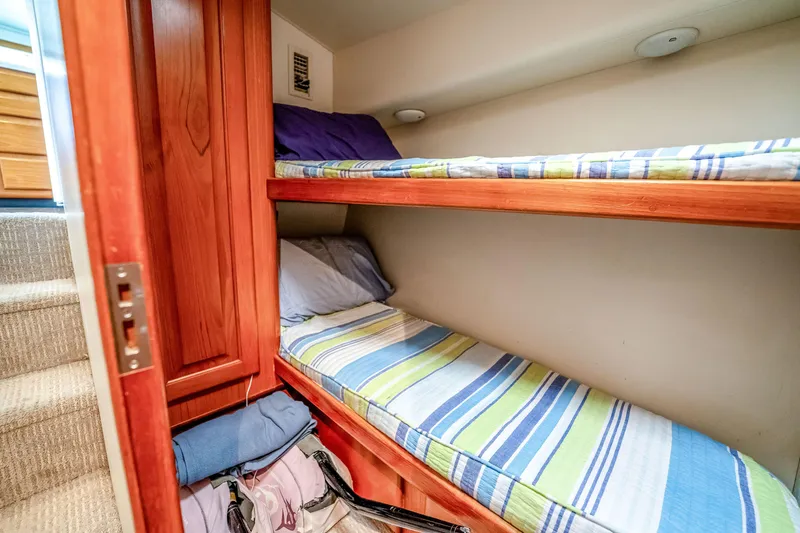 Slide: The Image of Bunk beds in a 1995 Viking 50 yacht cabin with striped bedding. - 28