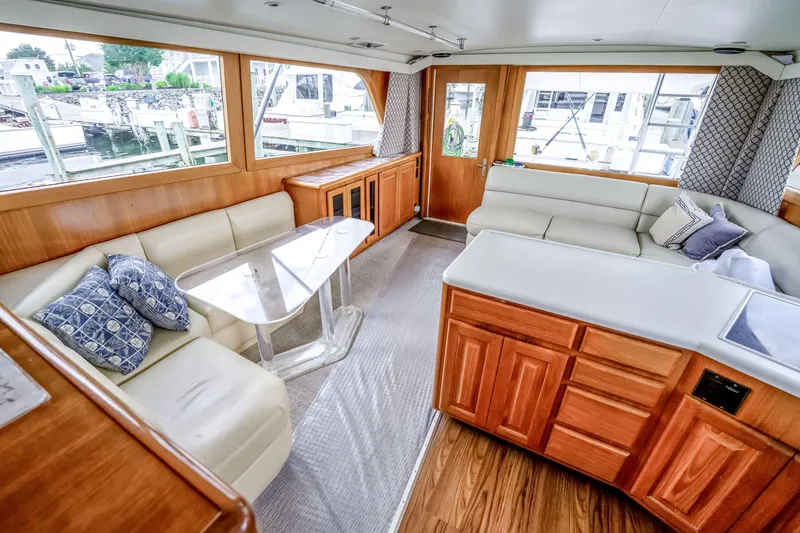 Slide: The Image of Luxurious interior of a 1995 Viking 50 yacht with plush seating and elegant wood finishes. - 31