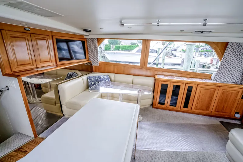 Slide: The Image of Luxurious interior of a 1995 Viking 50 yacht with plush seating and wooden cabinetry. - 32