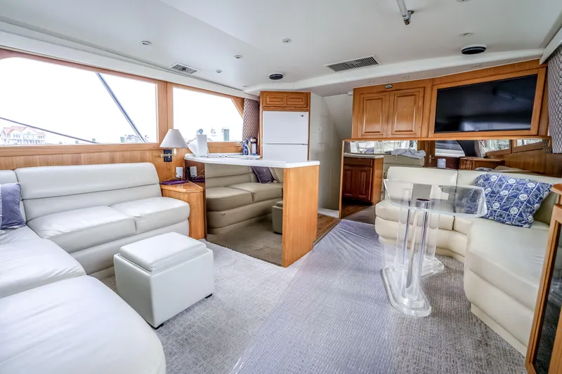 Slide: The Image of Luxurious interior of a 1995 Viking 50 yacht with white leather seating and wooden cabinetry. - 33