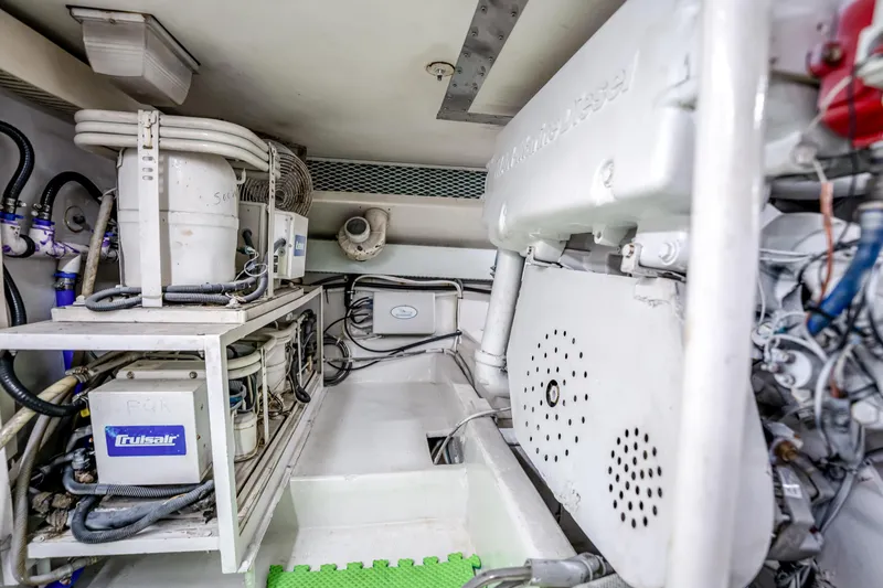 Slide: The Image of Engine room of a 1995 Viking 50 yacht, featuring mechanical equipment and piping. - 42