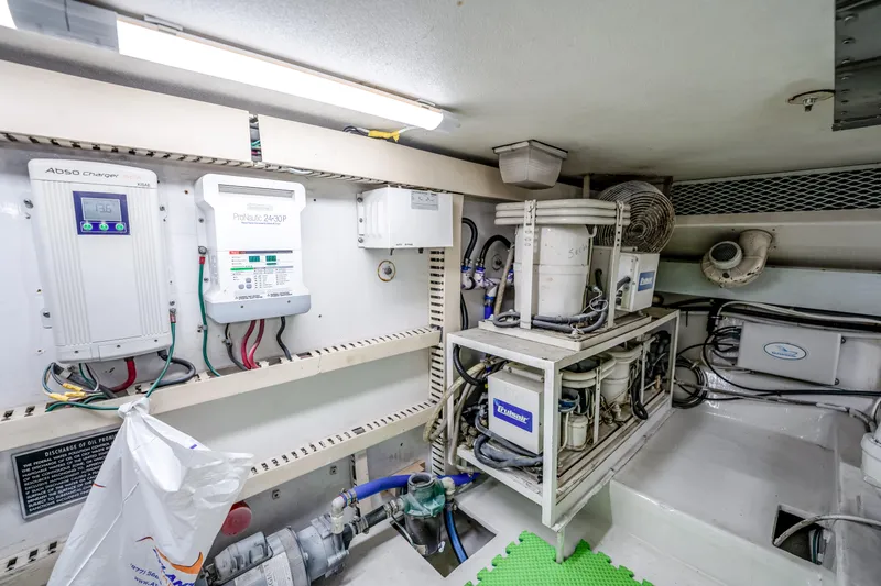 Slide: The Image of Engine room of a 1995 Viking 50 yacht, featuring electrical systems and equipment. - 43