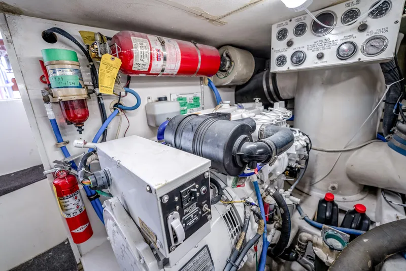 Slide: The Image of Engine room of a 1995 Viking 50 yacht with gauges and fire extinguishers. - 44