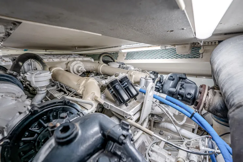 Slide: The Image of Engine room of a 1995 Viking 50 yacht, showcasing complex machinery and components. - 45