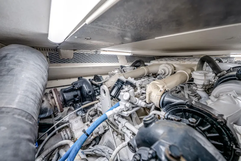 Slide: The Image of Engine room of a 1995 Viking 50 yacht, showcasing complex machinery and components. - 46