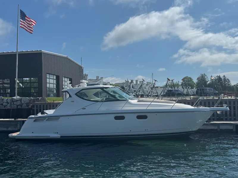 Slide: The Image of 2011 Tiara Yachts 3900 Sovran docked near a building with an American flag. - 0