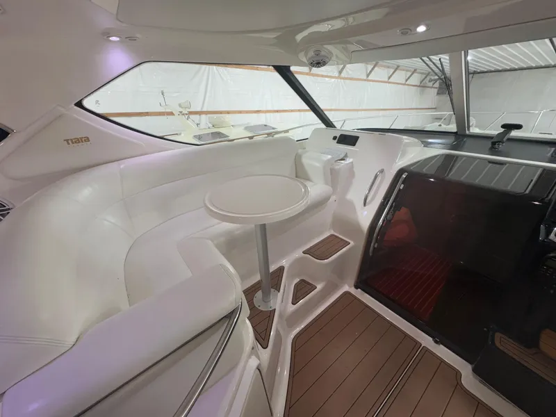 Slide: The Image of 2011 Tiara Yachts 3900 Sovran interior with white seating and table. - 12