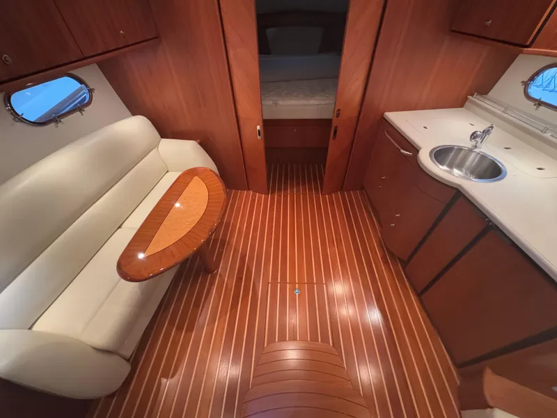 Slide: The Image of Interior of 2011 Tiara Yachts 3900 Sovran with wood flooring and elegant furnishings. - 14