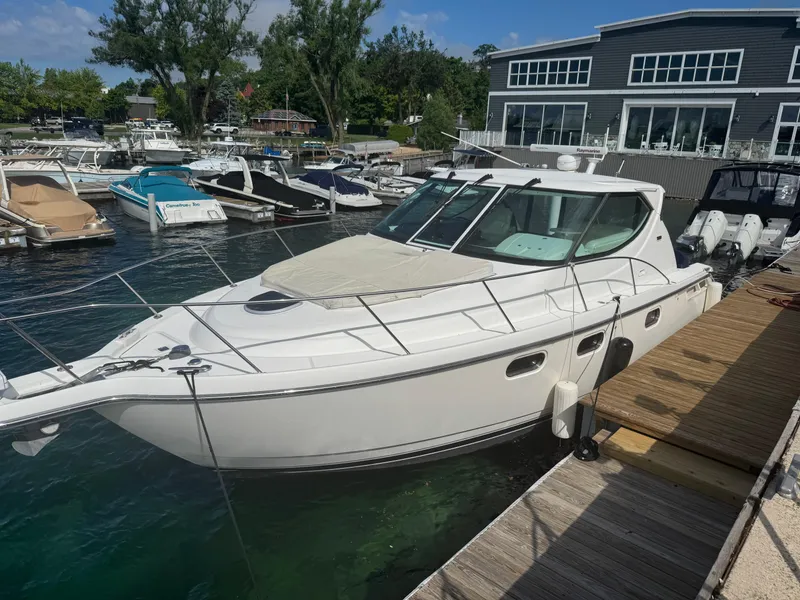 Slide: The Image of 2011 Tiara Yachts 3900 Sovran docked at a marina, surrounded by other boats. - 3
