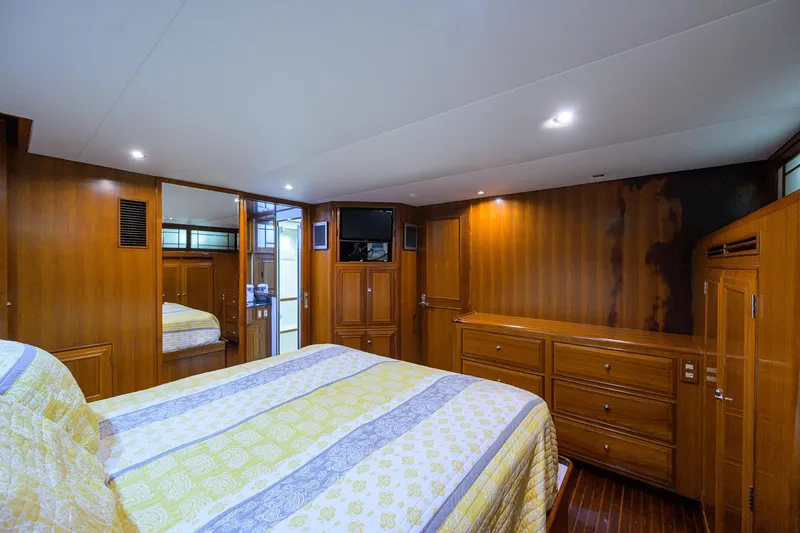 Slide: The Image of Luxurious bedroom interior of 2001 Ocean Alexander 602 yacht with wood paneling and cozy bedding. - 11