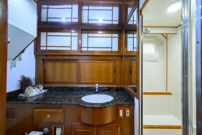 Slide: The Image of Luxurious bathroom interior of 2001 Ocean Alexander 602 yacht with wooden cabinetry and granite countertop. - 12