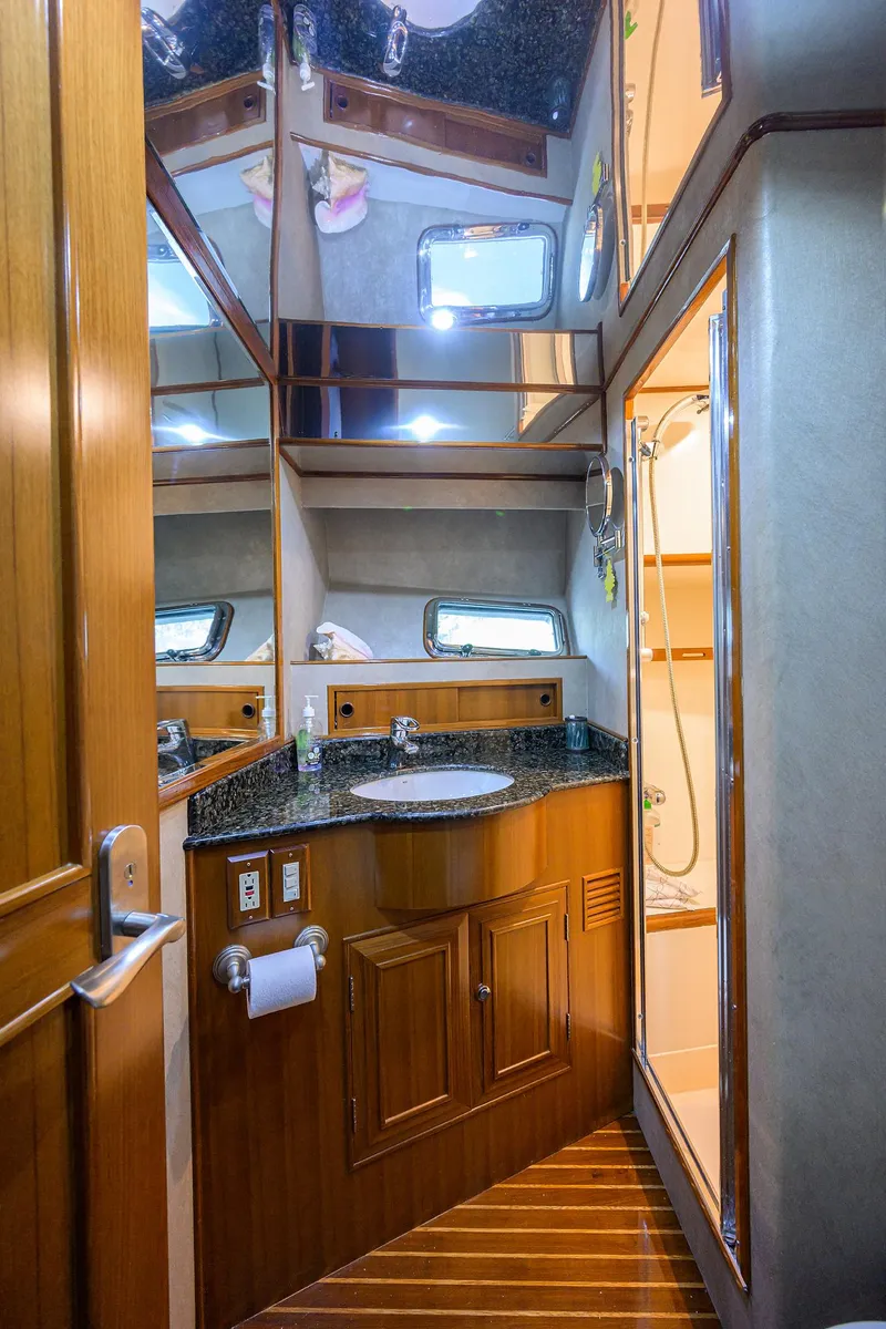 Slide: The Image of Luxurious bathroom in 2001 Ocean Alexander 602 yacht with wood accents and modern fixtures. - 18