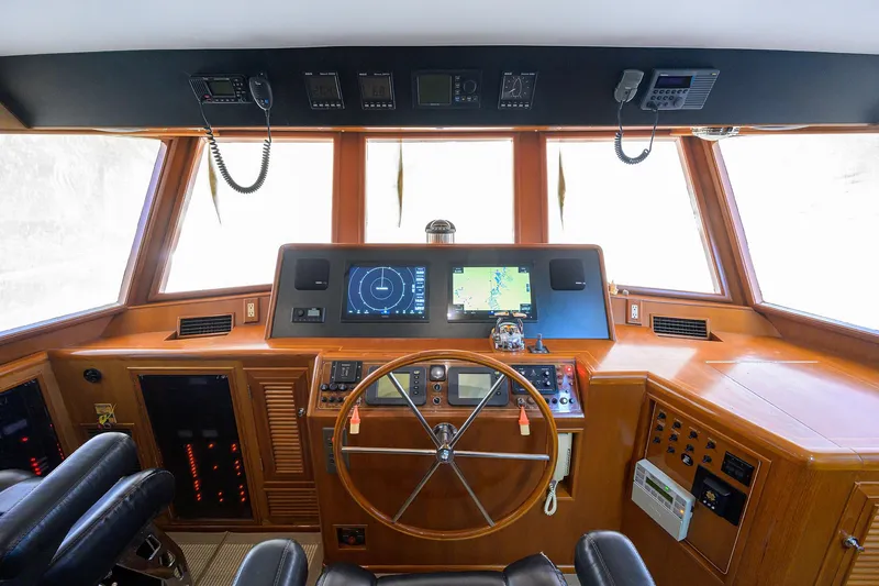 Slide: The Image of Cockpit of 2001 Ocean Alexander 602 yacht with navigation equipment and wooden steering wheel. - 25