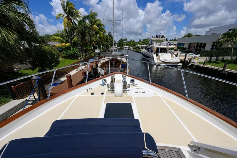 Slide: The Image of Ocean Alexander 602 yacht docked in a sunny canal, surrounded by palm trees, 2001 model. - 3