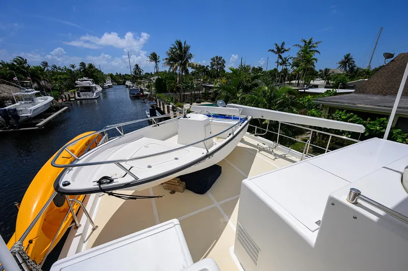 Slide: The Image of Ocean Alexander 602 yacht deck with lifeboat, docked in a tropical canal setting, 2001 model. - 35
