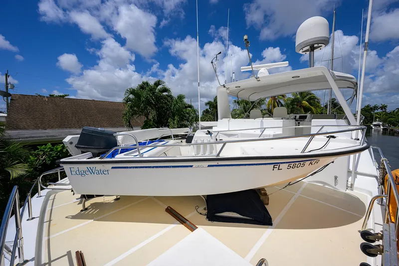 Slide: The Image of Ocean Alexander 602 yacht with EdgeWater boat on deck, 2001 model, under a clear blue sky. - 36