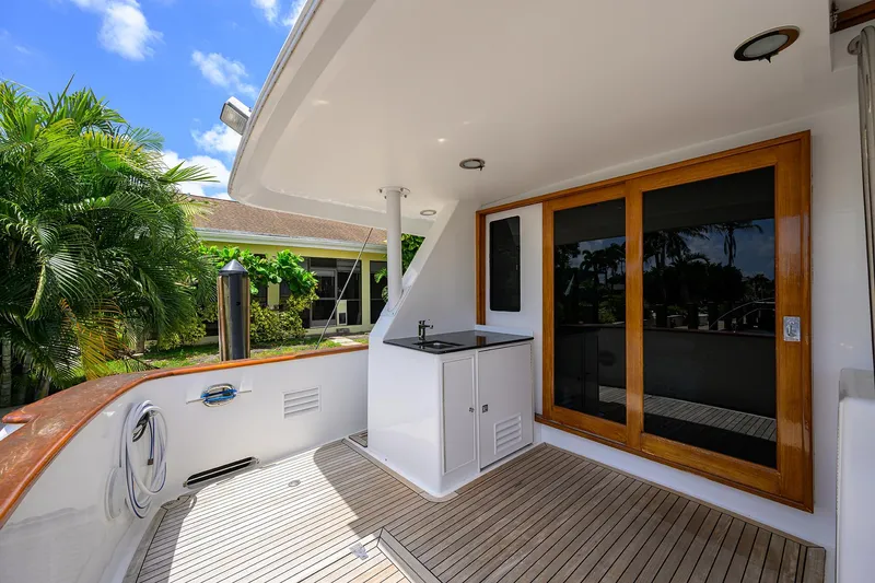 Slide: The Image of Outdoor deck of 2001 Ocean Alexander 602 yacht with wooden flooring and sliding glass doors. - 42
