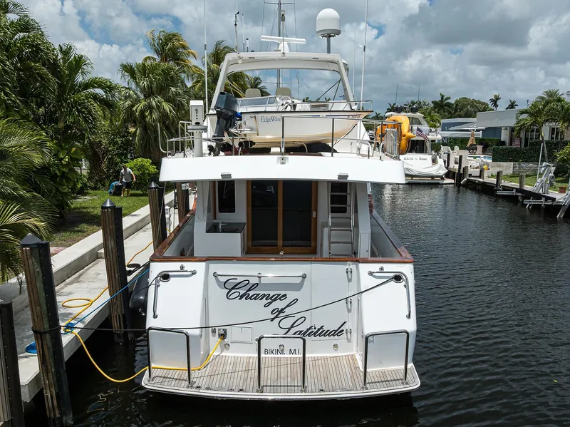 Slide: The Image of Ocean Alexander 602 yacht docked, rear view, "Change of Latitude," 2001 model, tropical setting. - 44