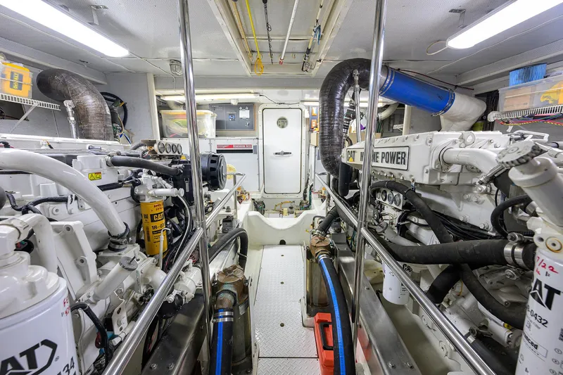 Slide: The Image of Engine room of 2001 Ocean Alexander 602 yacht, featuring dual CAT marine engines. - 46