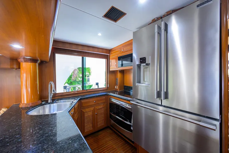 Slide: The Image of Luxurious kitchen in 2001 Ocean Alexander 602 yacht with stainless steel appliances and wood cabinetry. - 7