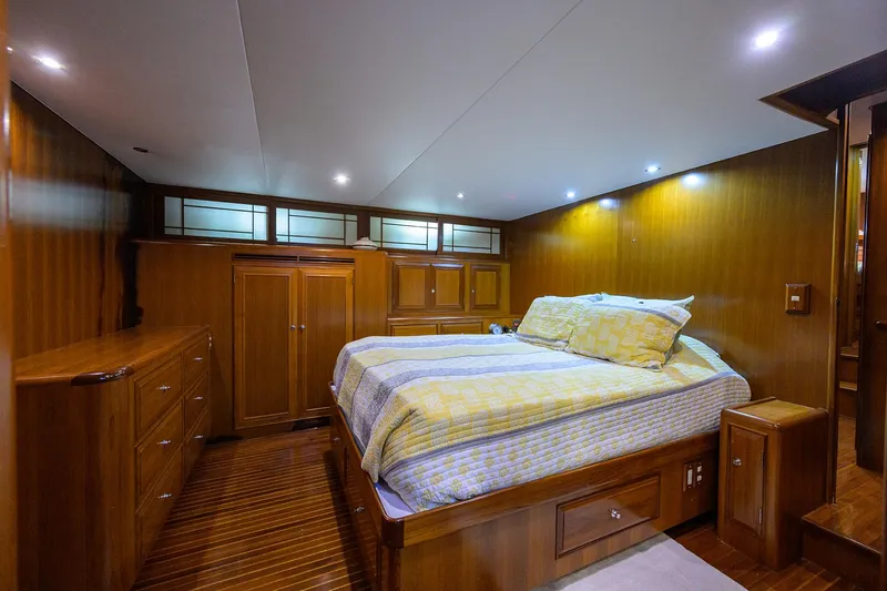 Slide: The Image of Luxurious 2001 Ocean Alexander 602 yacht bedroom with wood paneling and cozy bedding. - 9