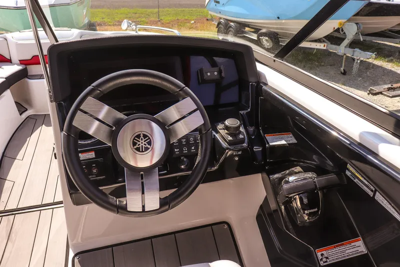 Slide: The Image of 2019 Yamaha Boats 242X E-Series steering wheel and dashboard controls. - 13