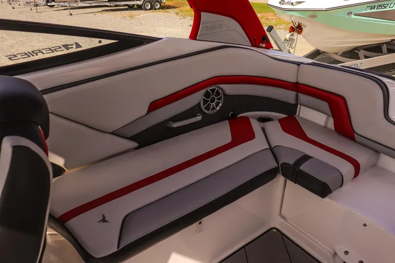 Slide: The Image of 2019 Yamaha Boats 242X E-Series interior with red and gray seating, featuring a speaker and cup holder. - 17