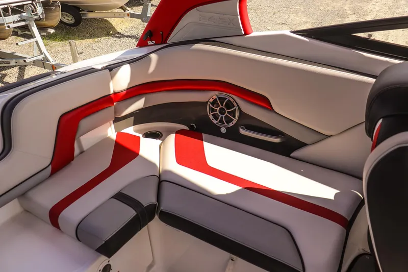 Slide: The Image of 2019 Yamaha Boats 242X E-Series interior with red and white seating and speaker detail. - 18