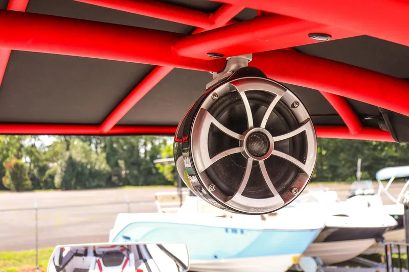 Slide: The Image of Close-up of a speaker on a 2019 Yamaha Boats 242X E-Series with red framework. - 22